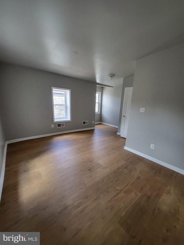 unfurnished room with wood-type flooring