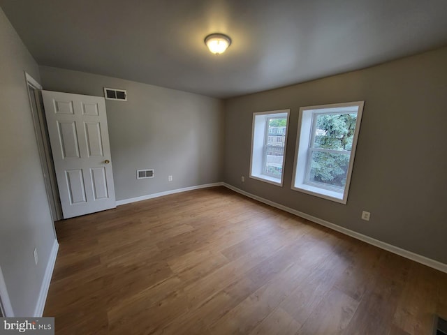 spare room with hardwood / wood-style flooring