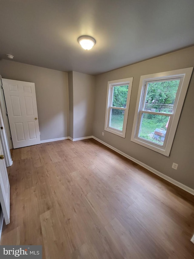 empty room with light hardwood / wood-style floors