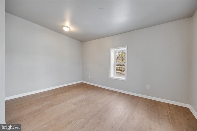 spare room with light hardwood / wood-style flooring