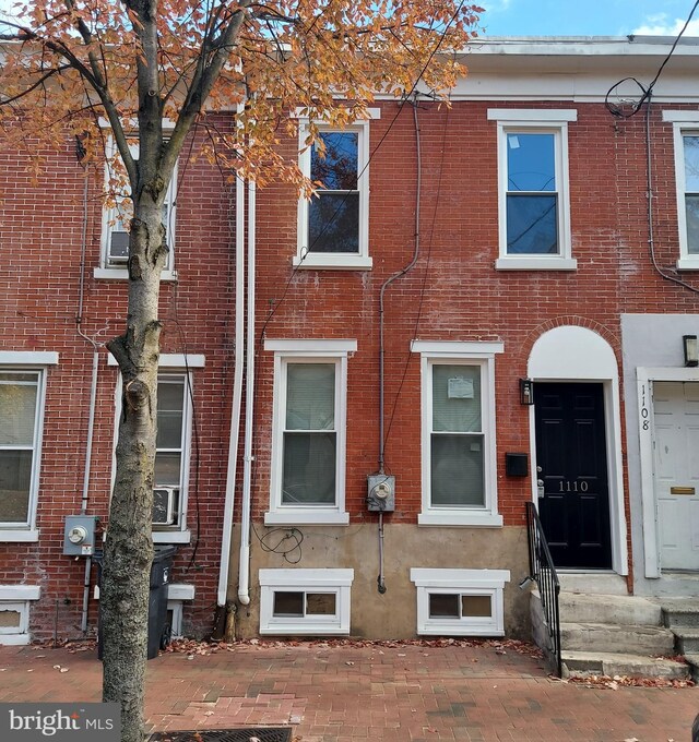 townhome / multi-family property with brick siding