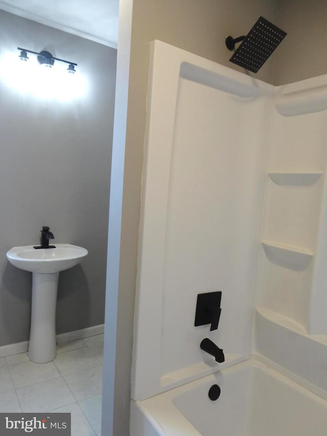 bathroom featuring tile patterned floors, sink, and  shower combination