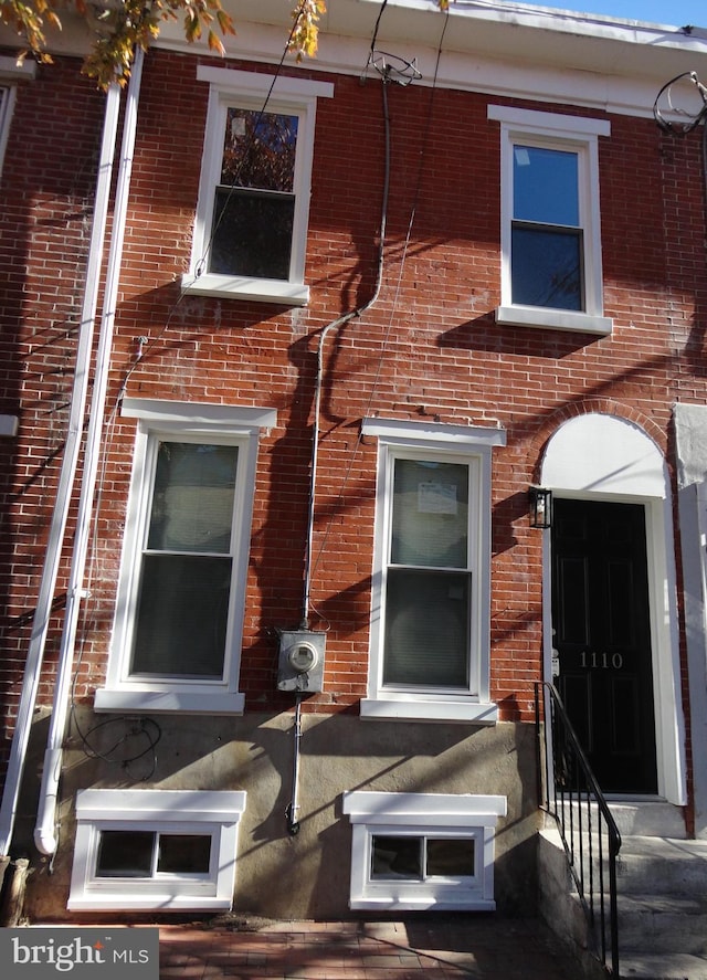 exterior space featuring brick siding and entry steps