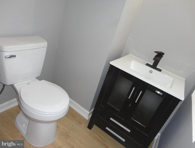 bathroom featuring hardwood / wood-style floors, vanity, and toilet