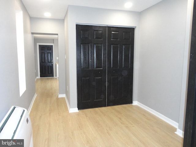 hallway with light hardwood / wood-style floors