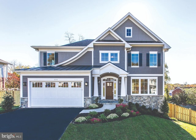 craftsman-style home with a front lawn and a garage