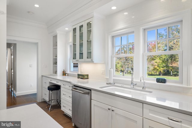 kitchen featuring crown molding, white cabinetry, sink, and dark hardwood / wood-style flooring