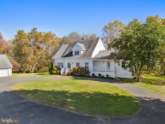 new england style home featuring a front lawn and a porch