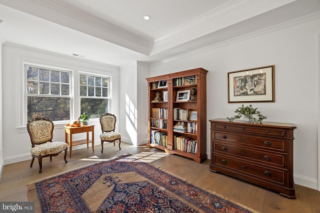 sitting room featuring hardwood / wood-style flooring and ornamental molding