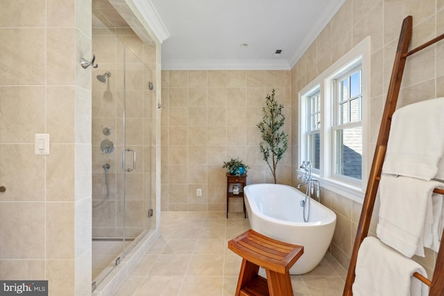 bathroom featuring tile patterned flooring, tile walls, ornamental molding, and separate shower and tub