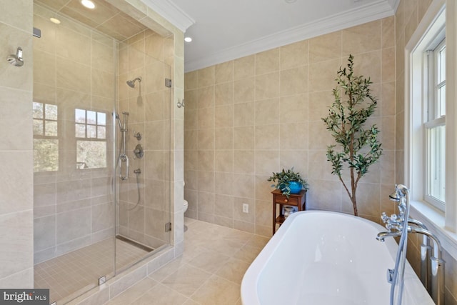 bathroom with plenty of natural light, shower with separate bathtub, tile walls, and crown molding