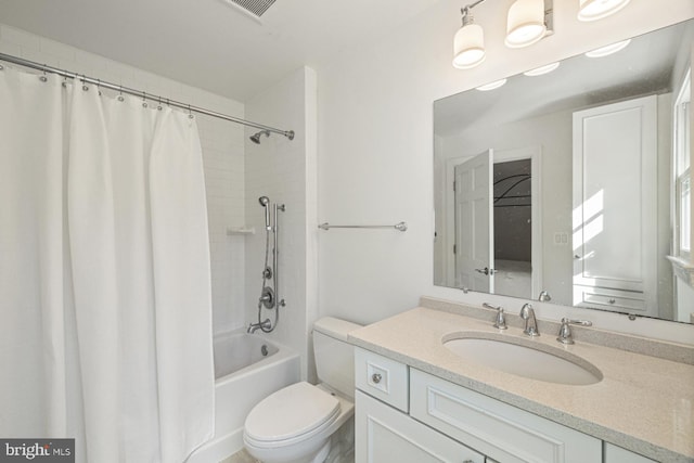 full bathroom featuring toilet, shower / tub combo with curtain, and vanity