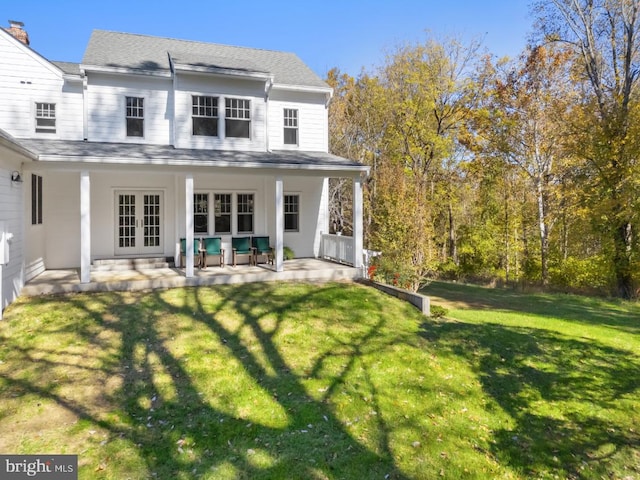 rear view of property with a patio area and a yard