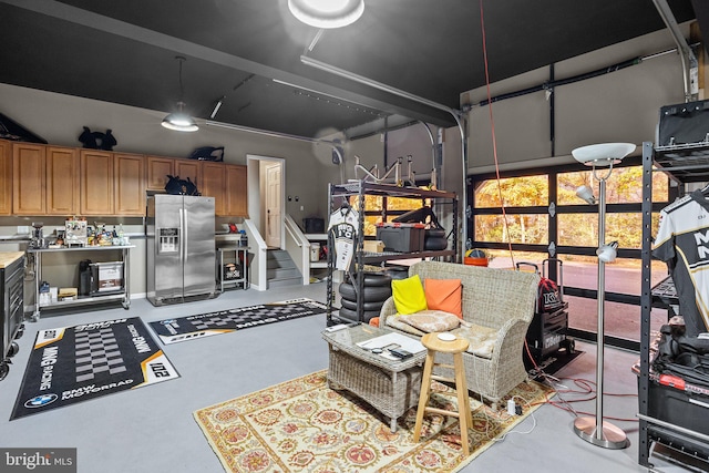 garage featuring stainless steel refrigerator with ice dispenser