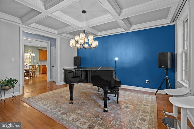 miscellaneous room featuring light hardwood / wood-style flooring, ornamental molding, beam ceiling, and coffered ceiling