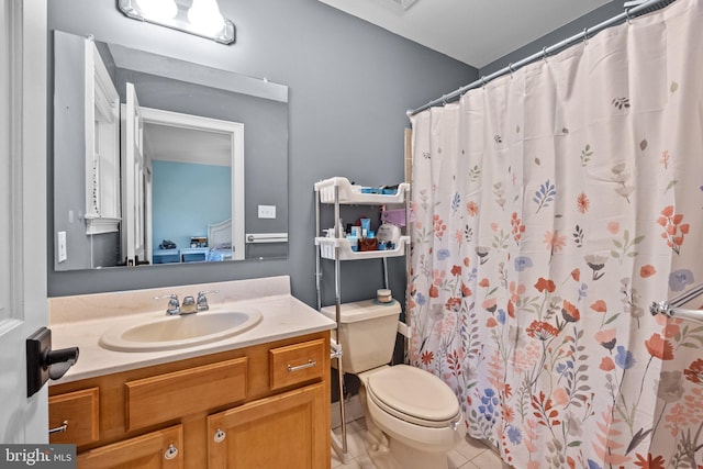 bathroom featuring vanity, a shower with curtain, toilet, and tile patterned flooring