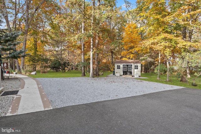 exterior space with a storage unit and a lawn