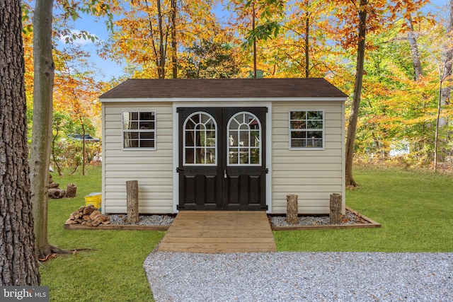 view of outbuilding with a lawn