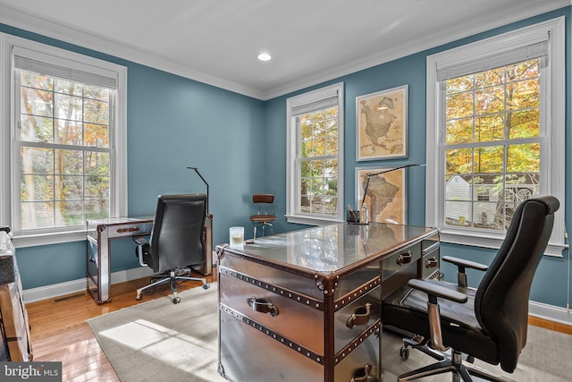 office area with crown molding and light wood-type flooring