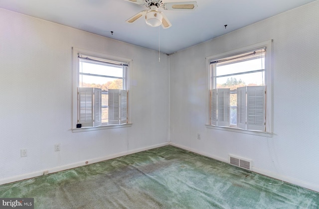 unfurnished room featuring a wealth of natural light, carpet flooring, and ceiling fan