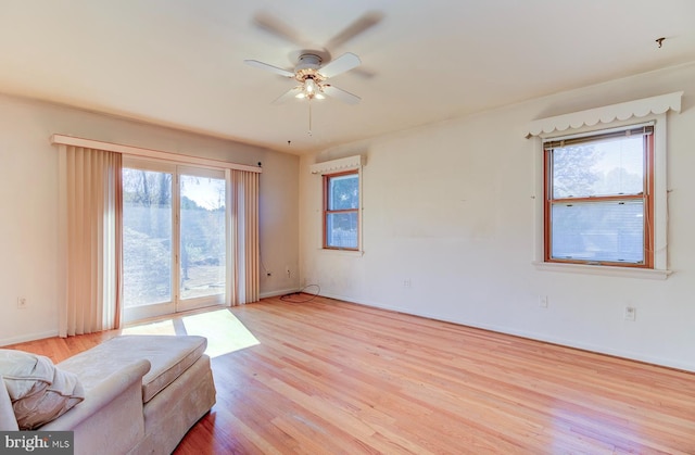 unfurnished living room featuring light hardwood / wood-style flooring and ceiling fan