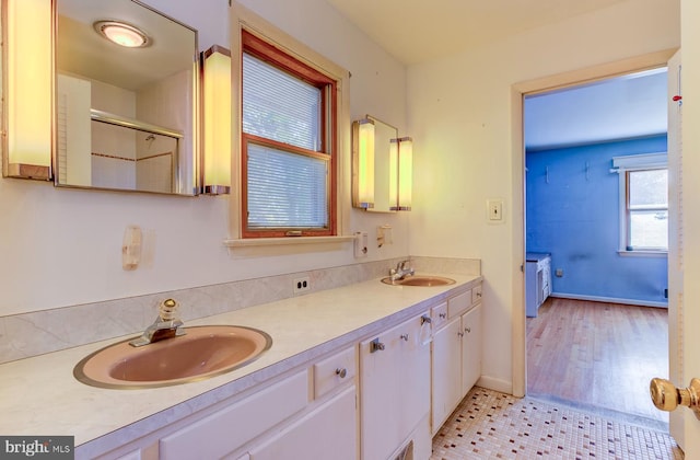 bathroom featuring vanity, a shower with shower door, and hardwood / wood-style flooring