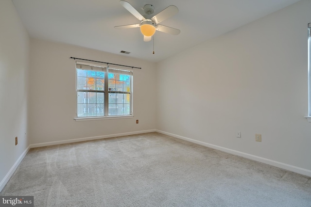 unfurnished room with ceiling fan and light colored carpet