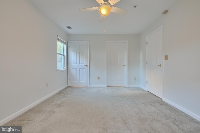 spare room with light carpet and ceiling fan