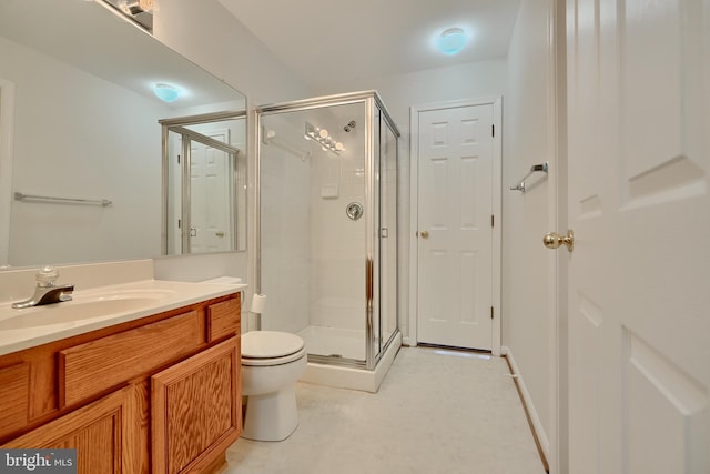 bathroom featuring vanity, toilet, and walk in shower