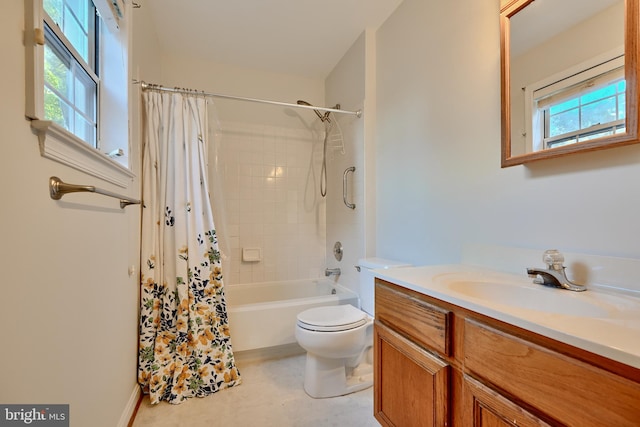 full bathroom featuring a wealth of natural light, vanity, shower / bath combo with shower curtain, and toilet