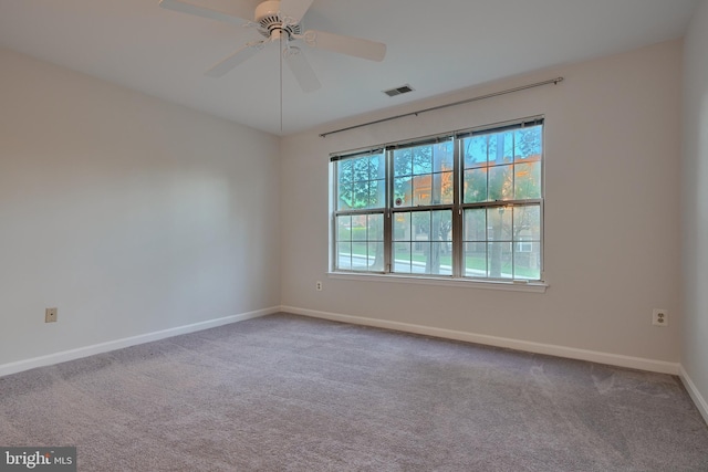 empty room with ceiling fan and carpet