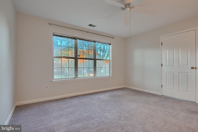 carpeted spare room with ceiling fan