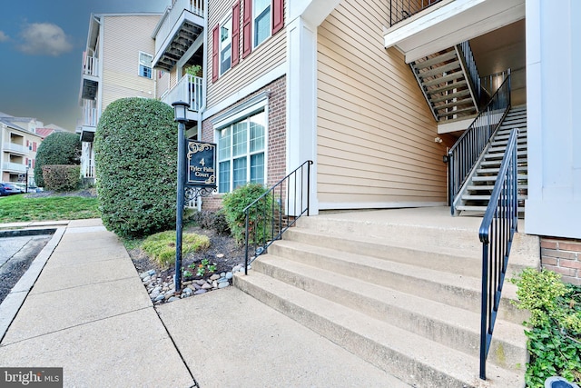 view of exterior entry featuring a balcony