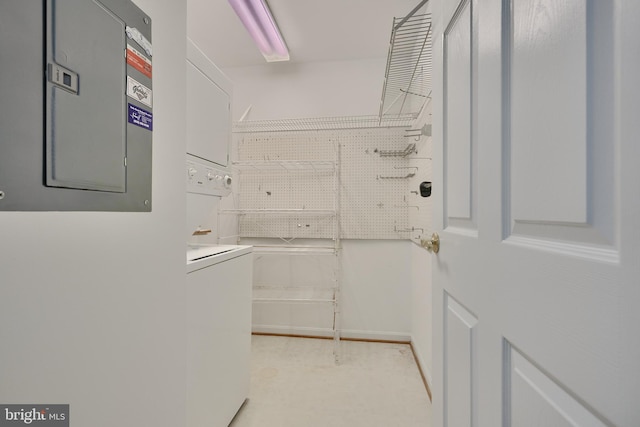 walk in closet featuring electric panel and stacked washer and dryer