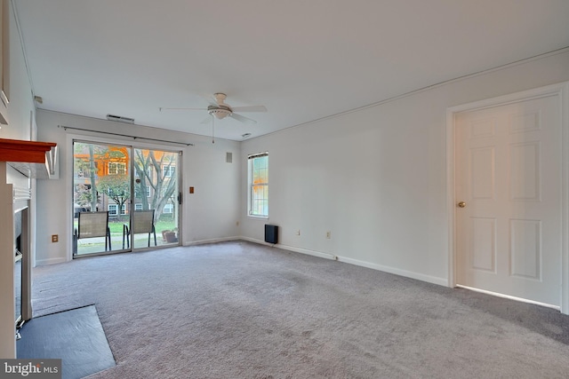 unfurnished living room featuring light carpet and ceiling fan