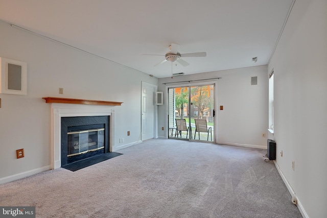 unfurnished living room with ceiling fan, crown molding, and carpet