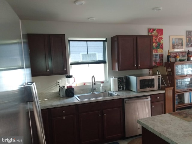 kitchen featuring dark brown cabinetry, appliances with stainless steel finishes, and sink