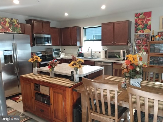 kitchen featuring appliances with stainless steel finishes, sink, and a kitchen island