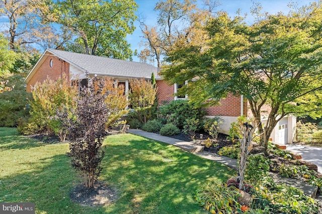 obstructed view of property with a front lawn and a garage