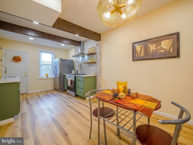 kitchen featuring green cabinetry, appliances with stainless steel finishes, sink, and light hardwood / wood-style flooring