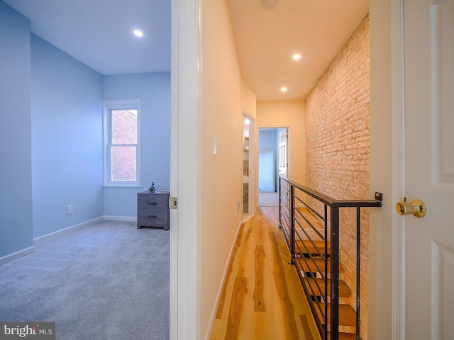 hallway with light hardwood / wood-style flooring