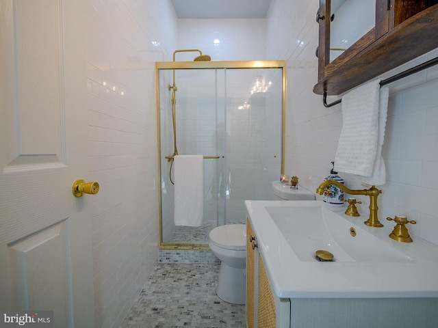 bathroom featuring tile walls, an enclosed shower, vanity, and toilet