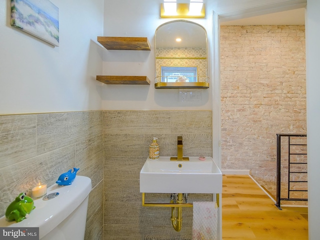 bathroom with hardwood / wood-style floors, sink, and toilet