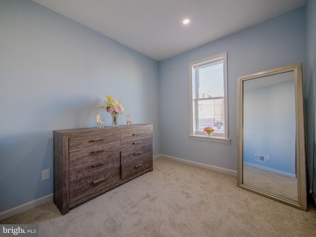 unfurnished bedroom featuring light carpet