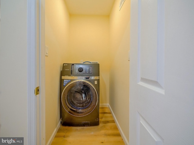 washroom featuring light hardwood / wood-style flooring and washer / clothes dryer