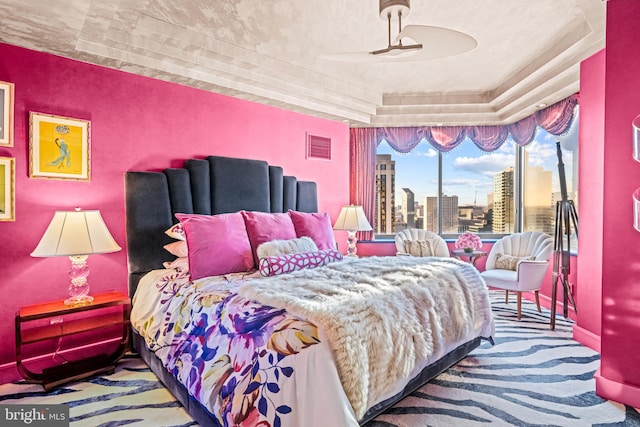 carpeted bedroom with a raised ceiling