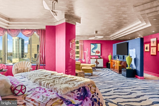 bedroom with carpet and a tray ceiling