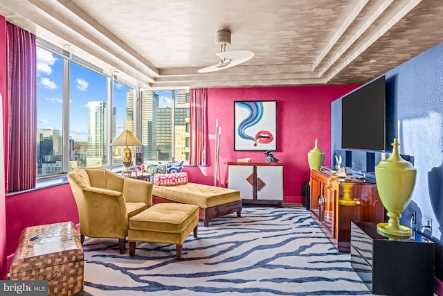 sitting room with carpet flooring and ceiling fan