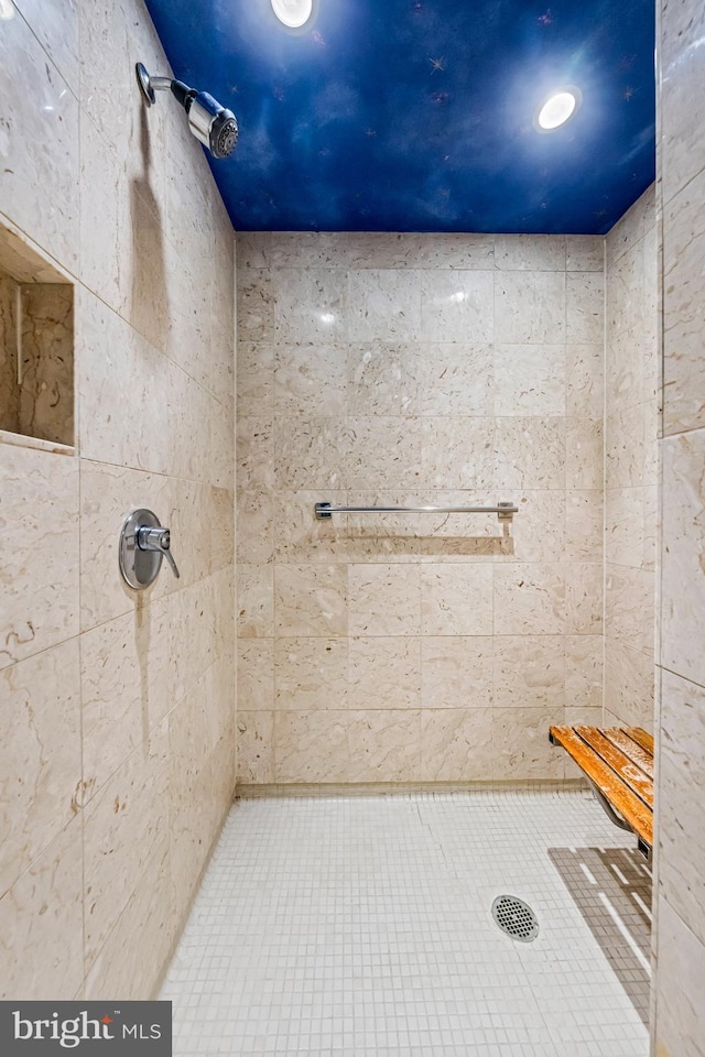 bathroom with a tile shower