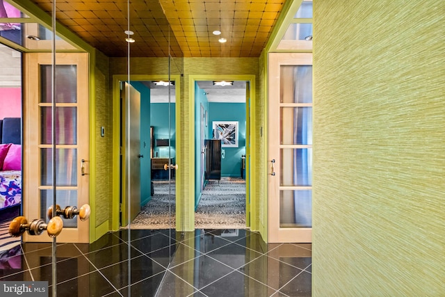 corridor with dark tile patterned flooring